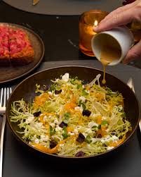Salad finished with vinaigrette at the table