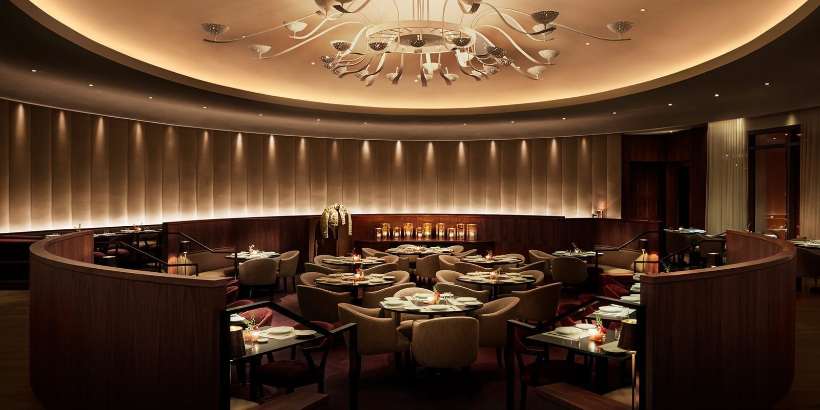 The sunken oval dining room of Matador Room beneath its restored chandelier
